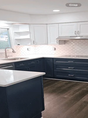 Two-tone kitchen with white and navy cabinets, white quartz counters, geometric tile backsplash, and island