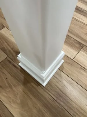 White painted base trim and quarter-round molding installed on engineered hardwood flooring