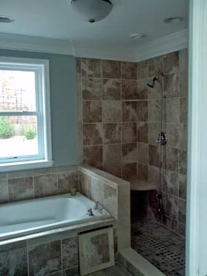 Master bathroom renovation with custom tile walk-in shower and soaking tub by Canvas Kitchens & Baths